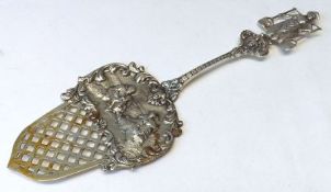A late 19th/early 20th Century Dutch Cast White Metal Server with figure-embossed and pierced blade,