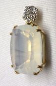 A yellow metal framed Milky Quartz stone Pendant with small Diamonds to the hanger, approximately
