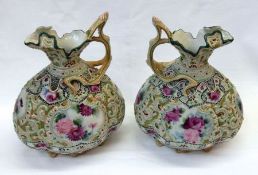 A pair of Noritake (Spider Mark) Ewers of compressed ovoid ribbed baluster form, painted in