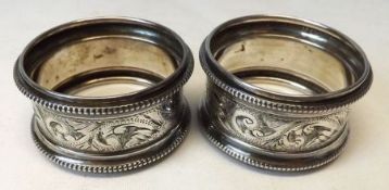 A pair of George V circular Napkin Rings with beaded and engraved detail, Birmingham 1921, (2)