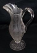 A decorative large Glass Ewer of tulip baluster form, etched with panels of berries and foliage,