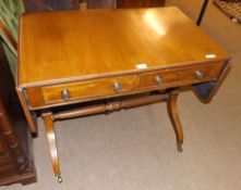 A Reproduction Mahogany Regency style Sofa Table, of rectangular form, each end fitted with a drop