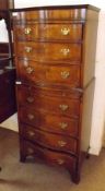 A Walnut small Serpentine Fronted Chest on Chest, the upper section with three graduated full
