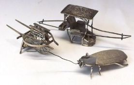 A group of three Oriental white metal Models, one of a double ended Rickshaw, one of a wheeled