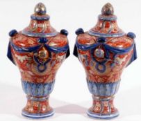 A pair of good 19th Century Imari large covered Urns of tapering baluster form, (one cover
