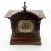 An early 20th Century German Stained Wooden Cased Mantel Clock of architectural design, and having