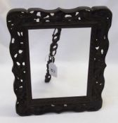 A decorative Oriental carved Hardwood easel backed Picture Frame, the pierced border decorated