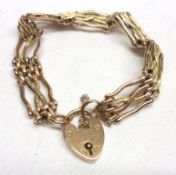 A late Victorian Gold Fancy Link Gate Bracelet with padlock, stamped “9ct”, and weighing