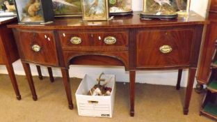 An early 19th Century Mahogany Bow Fronted Sideboard, satinwood strung and crossbanded top over a