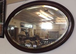 A Mahogany Oval Wall Mirror, with bevelled edge, 36” wide