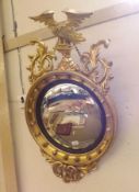 A Regency style Giltwood Convex Wall Mirror, the convex glass 15” diameter within an ebonised