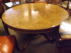 A Victorian Walnut Circular Pedestal Dining Table with boxwood strung top over a baluster support