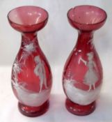 A pair of Cranberry Glass Vases, painted in the manner of Mary Gregory with motifs of a boy and a