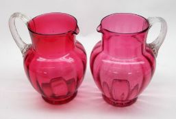 A Cranberry Glass Jug of moulded baluster form, with a clear glass and reeded looped handle, circa