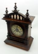 An early 20th Century Stained Wooden Cased German Mantel Clock, the composition dial with Roman