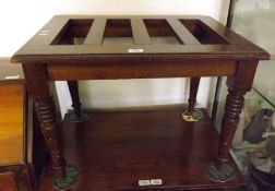 A Victorian Mahogany Case Stand of typical rectangular form, with plain frieze and raised on ring