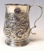 A George III small Christening Tankard of baluster form, later embossed with flowers, scrolls and