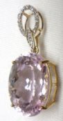 A large yellow metal framed Pink Kunzite oval stone Pendant with small Diamonds to the ringlet