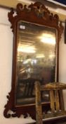 A Mahogany Chippendale style Wall Mirror, the top crested with a gilded ho-ho bird and with fretwork