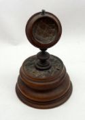 An early 20th Century Olive Wood Watch Stand with turned circular base, pedestal holder, 8 ½” tall