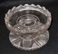 A small Lead Crystal Tazza of circular form with a hipped embossed rim, raised on a multi-knopped