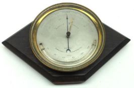 A late 19th Century Brass Cased Aneroid Barometer with silvered dial and attached curved
