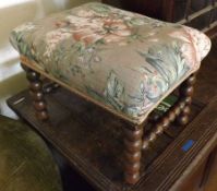 A Victorian Small Stained Oak Footstool with bobbin-turned supports and “H” stretcher, and floral