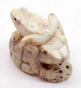 An Oriental composition Netsuke modelled as Frogs with a Sponge, 2” high