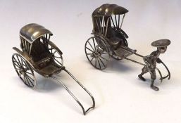 Two Oriental white metal models of Rickshaws, (one with figure), each approximately 3” long, (2)