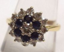 A hallmarked 18ct Gold all small Diamond/Sapphire set Cluster Ring of flower-head design