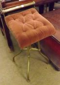 A Brass Framed Square Adjustable Piano Stool with pink button back upholstered seat, central