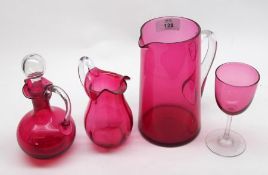 A small collection of Cranberry Glass wares comprising:  A Lemonade Jug with clear handle, a Wine