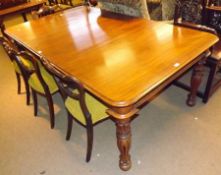 A Victorian Mahogany extending Dining Table, with moulded edge and rounded corners, raised on