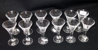 A set of twelve moulded Glass Drinking Glasses of shaped circular conical form, with plain stems and