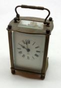 A 1st quarter of the 20th Century French Brass and Glass Cased Carriage Timepiece, with black