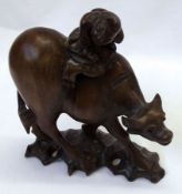 An Oriental Hardwood Model of a Figure on an Ox, 6 ½”