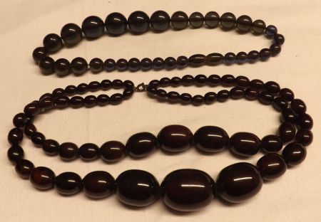 A Double Strand of Cherry Amber type graduated Beads and one other (2)