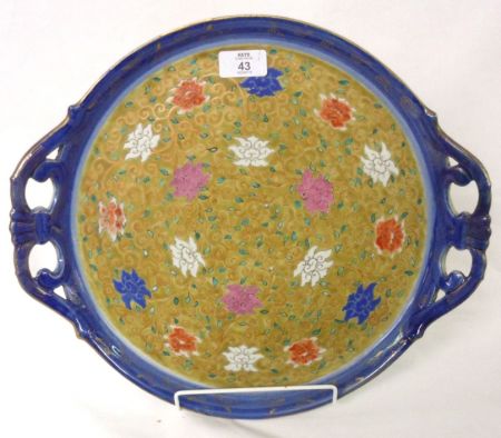 An Oriental two-handled circular Dish, decorated in puce, underglaze blue, iron red and famille