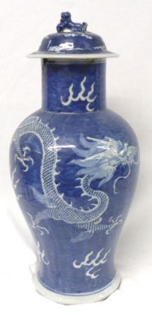 An Oriental Large Covered Baluster Vase, painted in underglaze blue with dragons and smoke clouds,