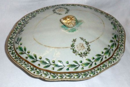 A Chinese Export Armorial Oval Covered Tureen, painted in famille verte with foliage and garlands,