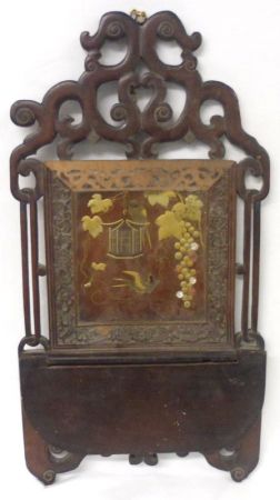 An Oriental Japanned and Lacquered Treen Wall Bracket, with a scrolled pediment over a panel