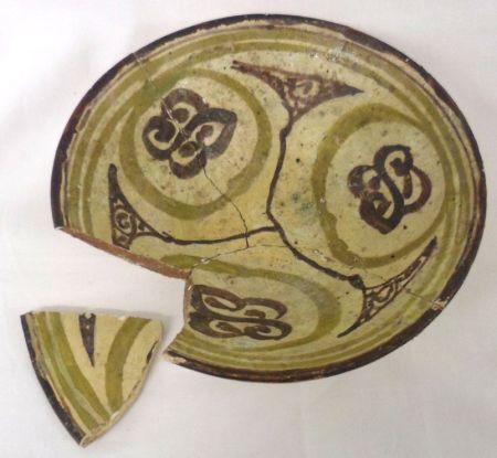 An Oriental Pottery Circular Bowl, decorated with treacle geometric designs with pale green