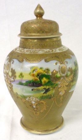 A Noritake Covered Baluster Vase, decorated in colours with panels of river scenes on a gilded