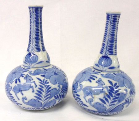 A pair of Oriental Balustered Spill Vases, decorated in underglaze blue with animals and foliage, 7”