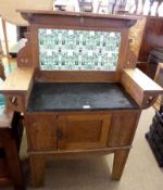 An Arts & Crafts Oak Wash Stand, inset with a green printed tiled back over slate inset, and the two