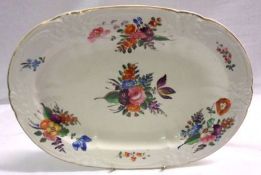 A 19th Century Derby Platter, painted in colours with sprigs and sprays of stylised foliage within a