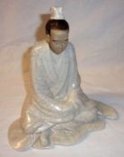 An Oriental crackle glaze Model of a kneeling figure, 8” high