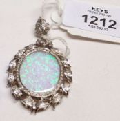 A high grade precious metal oval Pendant with large Opal type panel to the centre, further set to