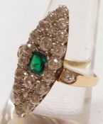 An unmarked precious metal Marquise design Ring, set to the centre with a square cut Emerald