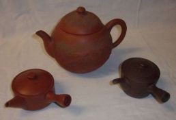 An Oriental Redware Teapot of globular form; together with two further Oriental Pottery Containers